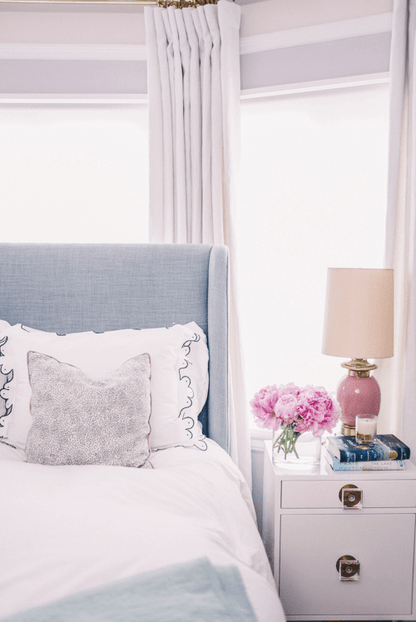 Confetti Cream & Black with Rose Pink French Piping Custom Designer Pillow from Arianna Belle on bed | home of Julia Berolzheimer