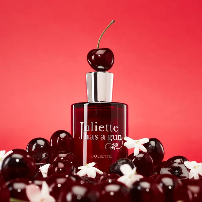 Juliette Has A Gun Juliette Eau de Parfum bottle topped with a cherry on dark cherries