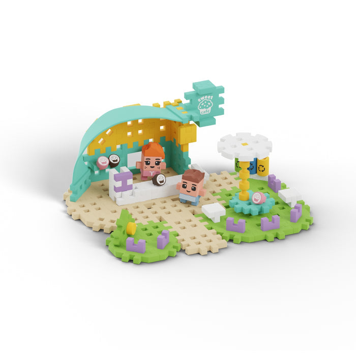 Marioinex Mini Waffle City is a toy building set with two blocky human figures at a sushi stand, featuring a green and yellow canopy, white sushi counter, flower-shaped table, and playful elements for creative STEM learning.