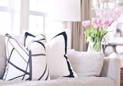 Channels Ebony & Ivory with Solid White with Grosgrain Ribbon Border Custom Designer Pillow on sofa | Arianna Belle